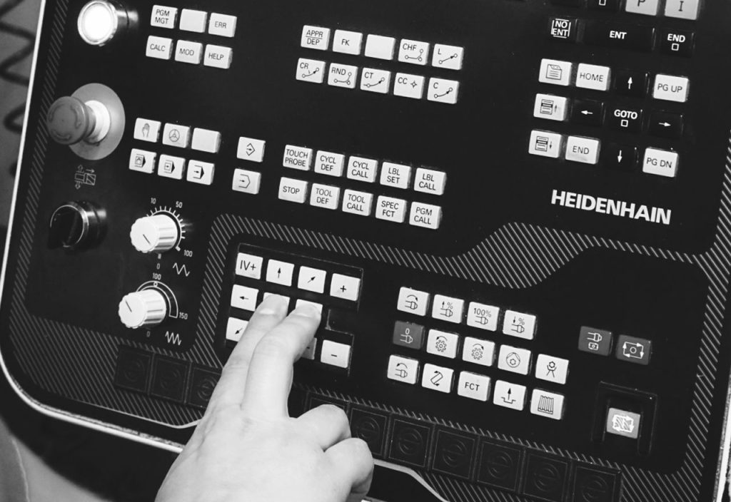 Eine Person bedient eine Bedienfläche einer Maschine mit 2 Fingern